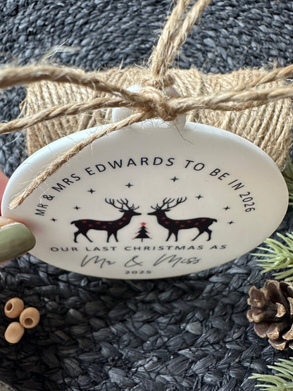 Personalized Christmas ornament with reindeer design and text on a textured surface.