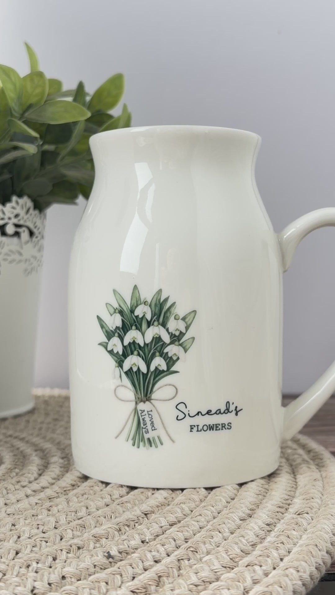 Personalised birth flower jug video showing the January snowdrop design and June honeysuckle design, with personalised names, mini message tags and matching birth flower meanings in English and Welsh.